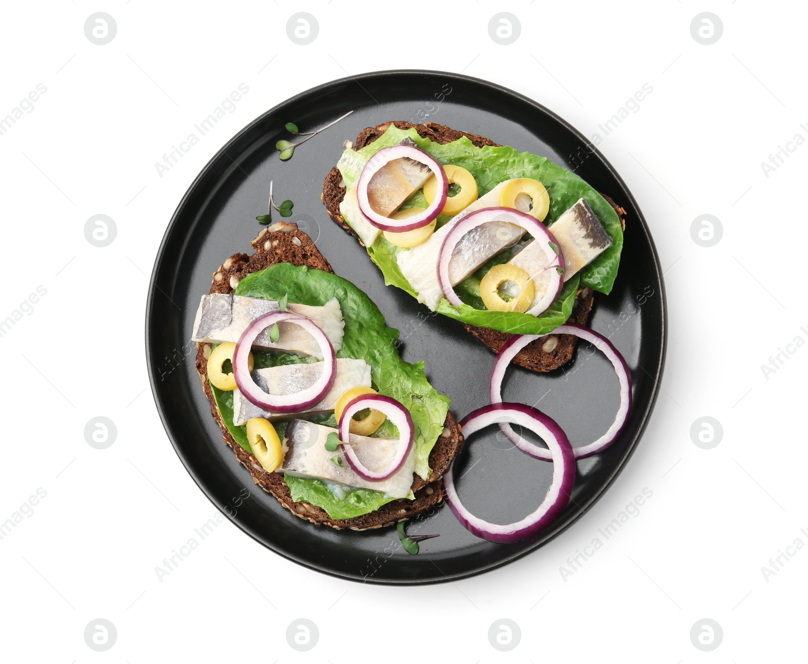 Photo of Tasty sandwiches with herring, onions, lettuce and olives isolated on white, top view