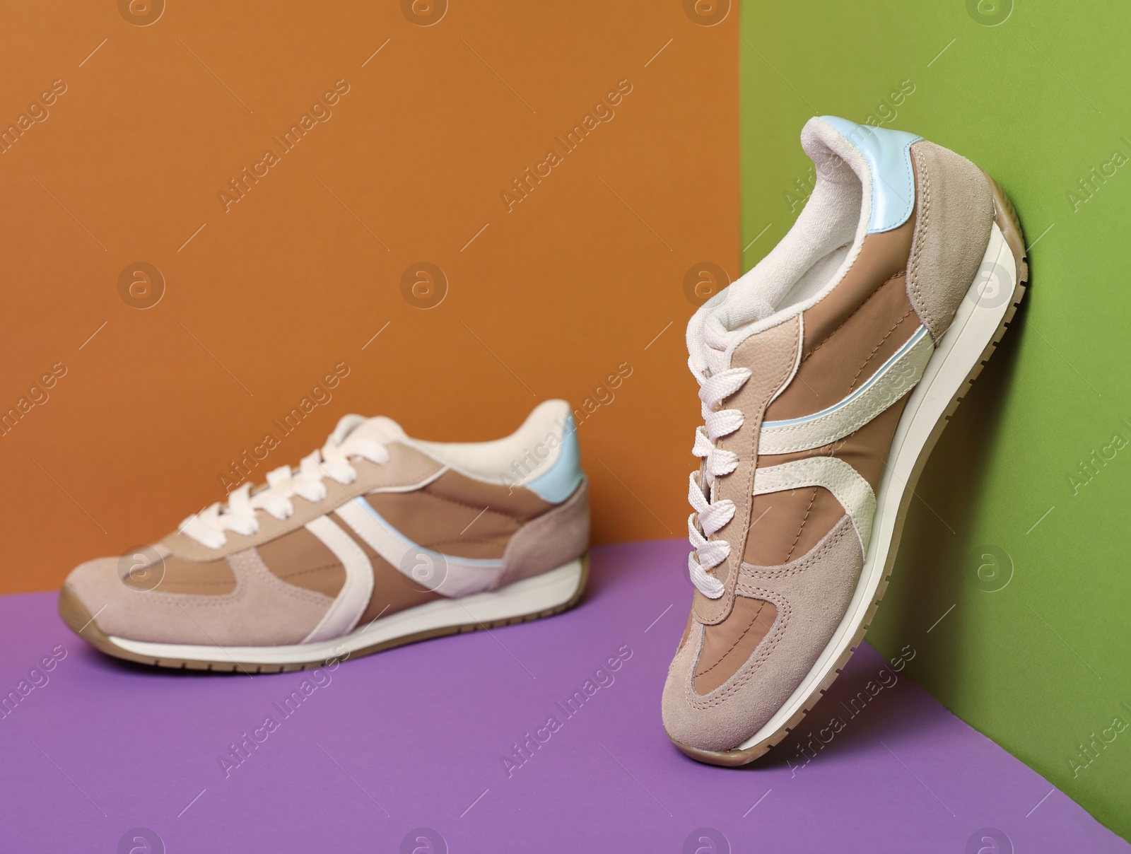 Photo of Pair of stylish sneakers on color background. Space for text