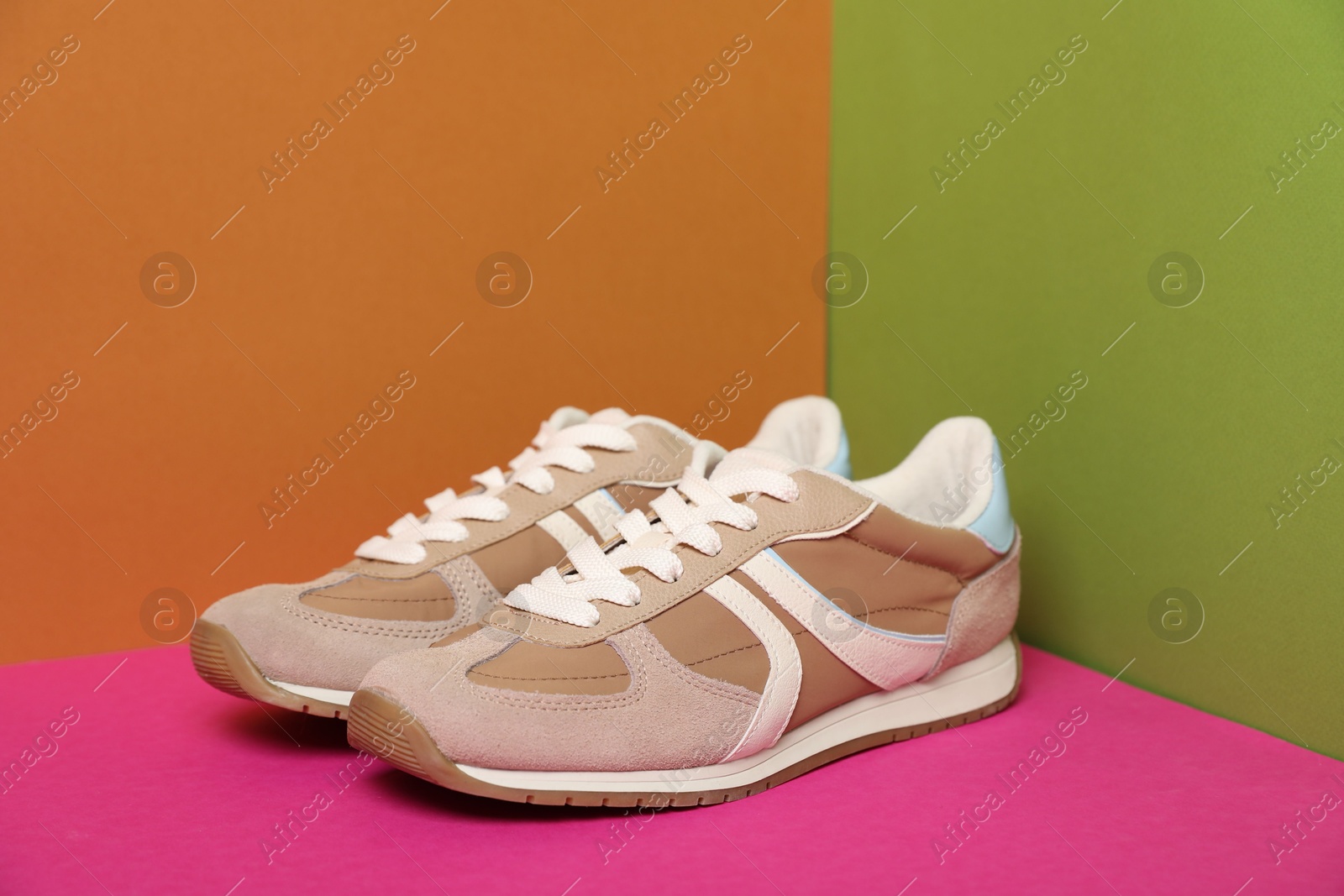 Photo of Pair of stylish sneakers on color background. Space for text