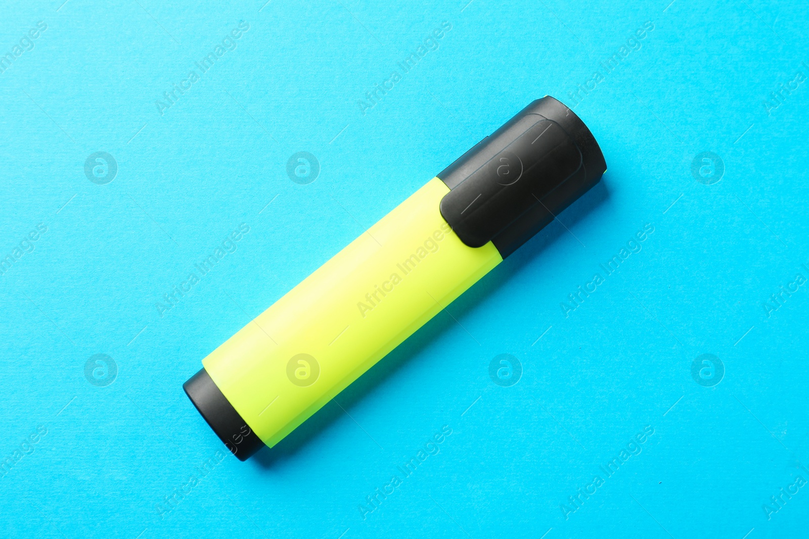 Photo of Bright highlighter on light blue background, top view