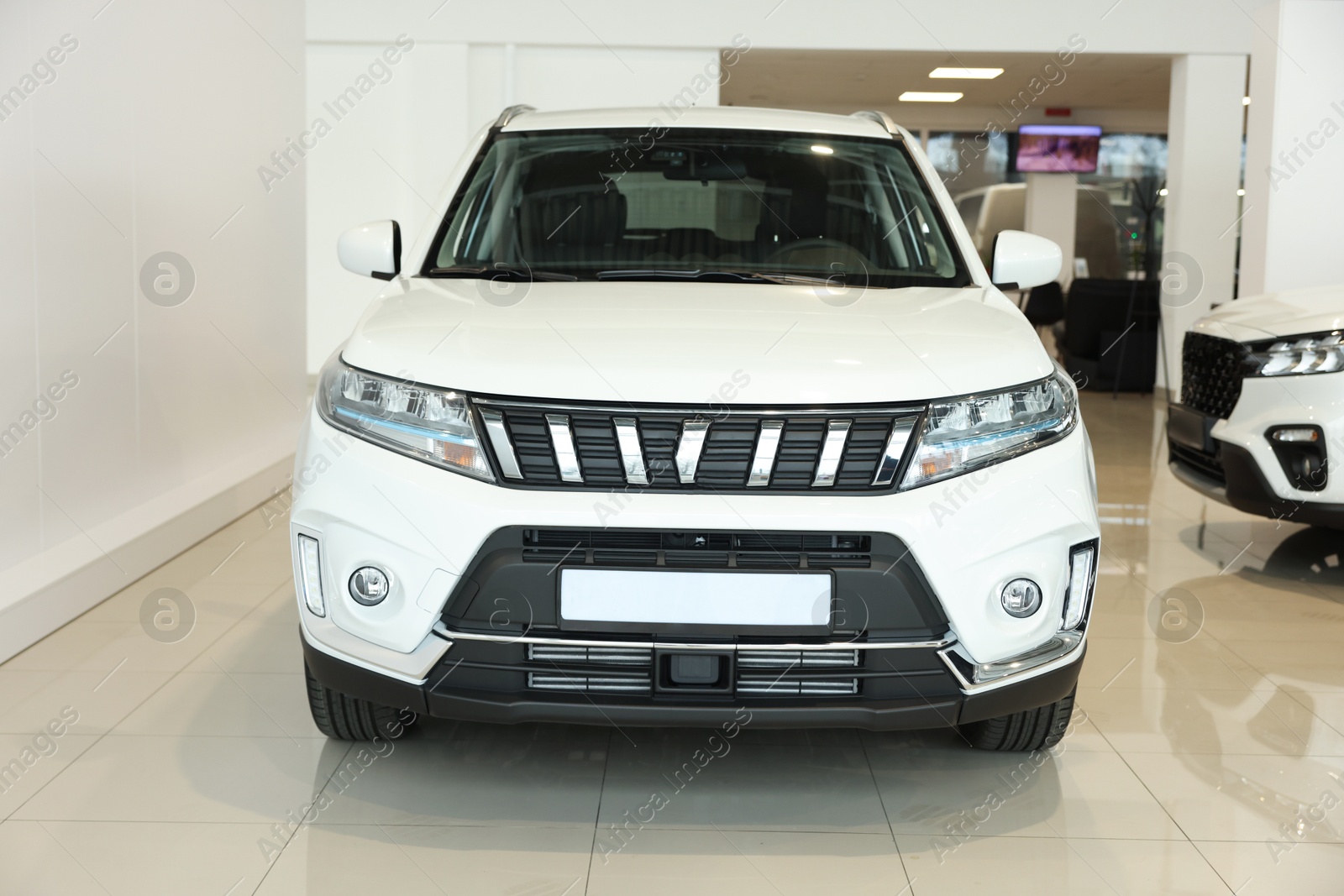 Photo of Luxury vehicle. New modern white car in salon