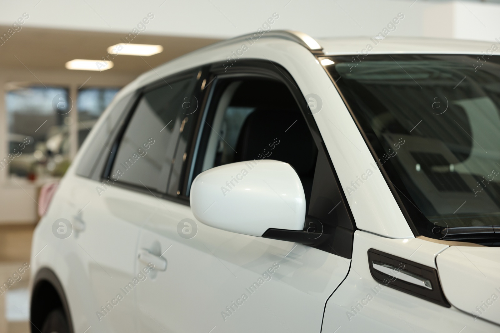 Photo of New modern white car in salon, closeup