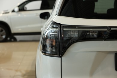 Photo of New modern white car in salon, closeup