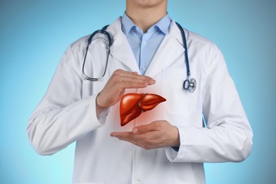 Image of Doctor holding illustration of liver on color background, closeup