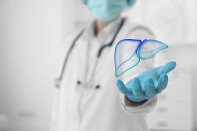 Image of Doctor holding illustration of liver indoors, closeup