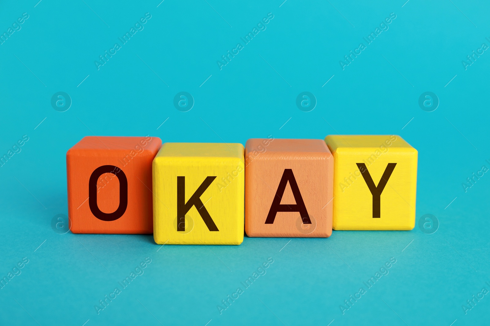 Image of Colorful cubes with word Okay on light blue background