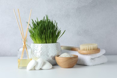 Photo of Spa composition with wheatgrass and sea salt on white table