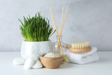 Photo of Spa composition with wheatgrass and sea salt on white table