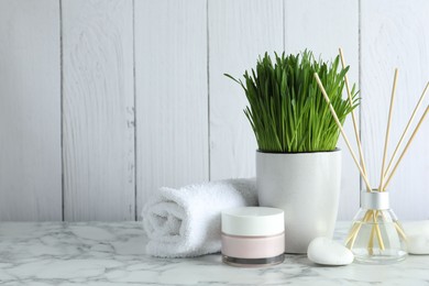 Photo of Spa composition with wheatgrass on white table. Space for text