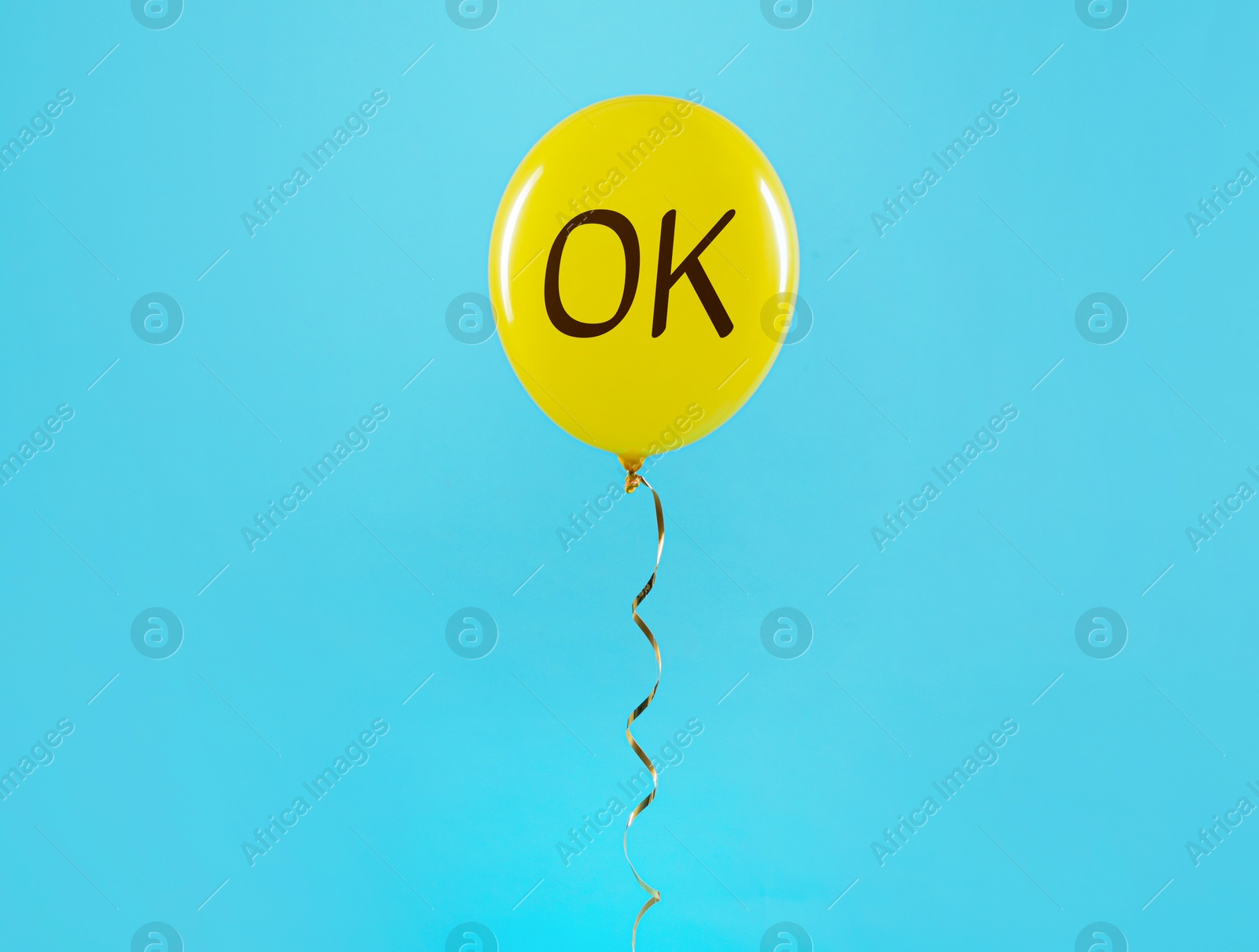 Image of Yellow balloon with abbreviation OK on light blue background