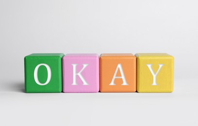 Image of Colorful cubes with word Okay on light grey background