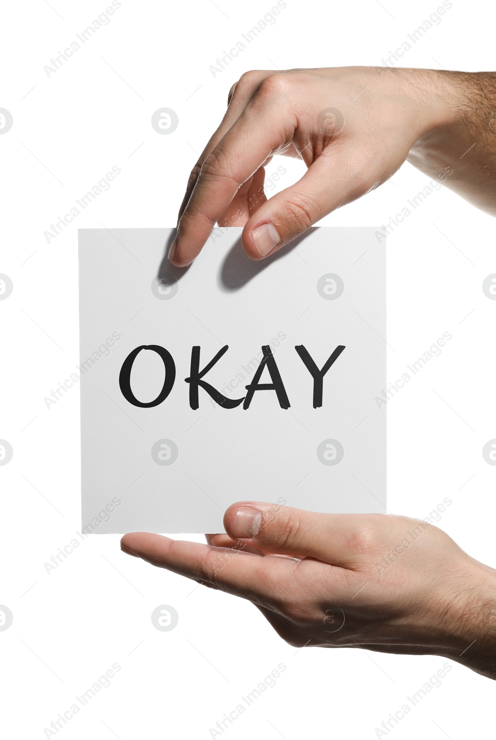 Image of Man holding sheet of paper with word Okay on white background, closeup