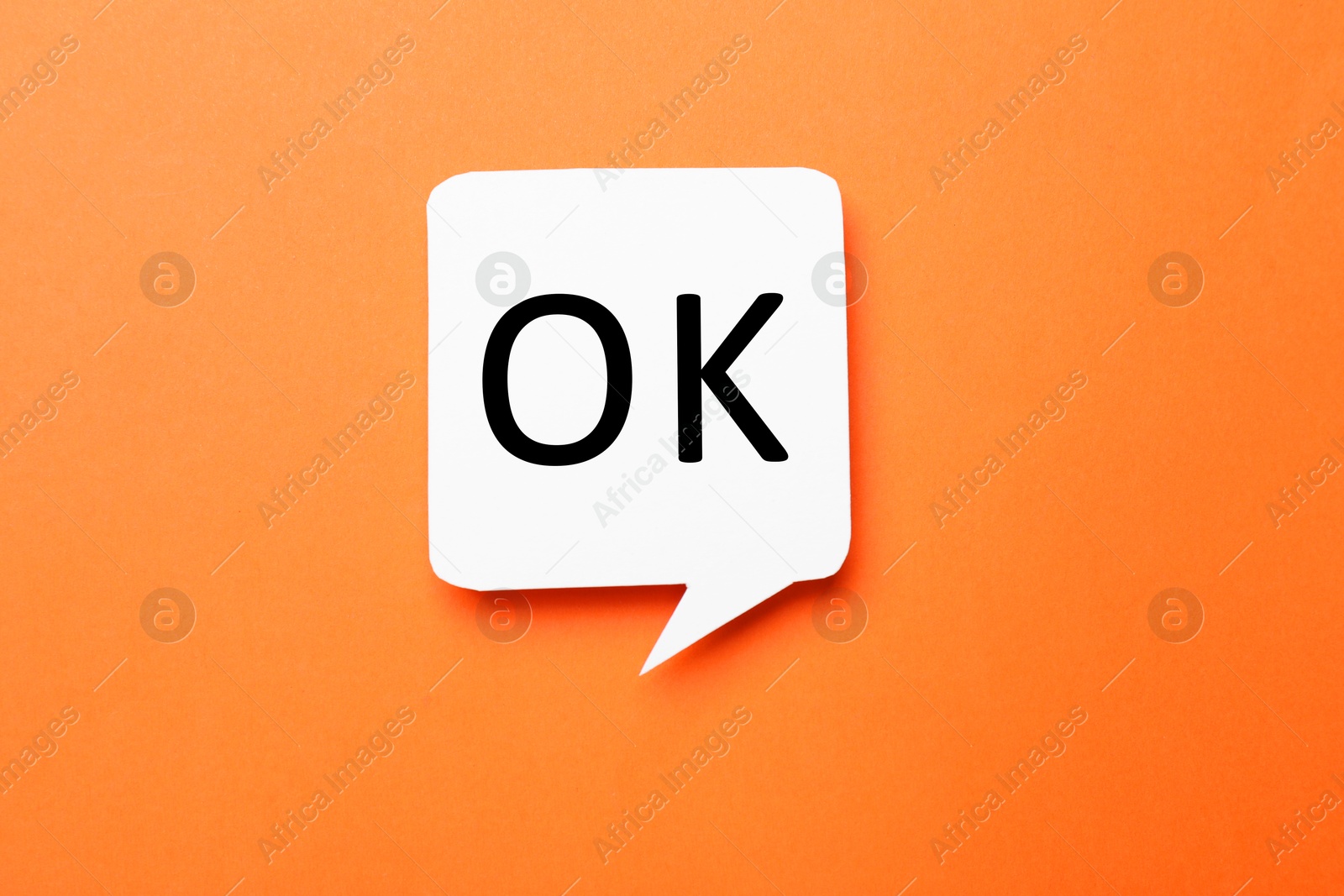 Image of Speech bubble with abbreviation OK on orange background