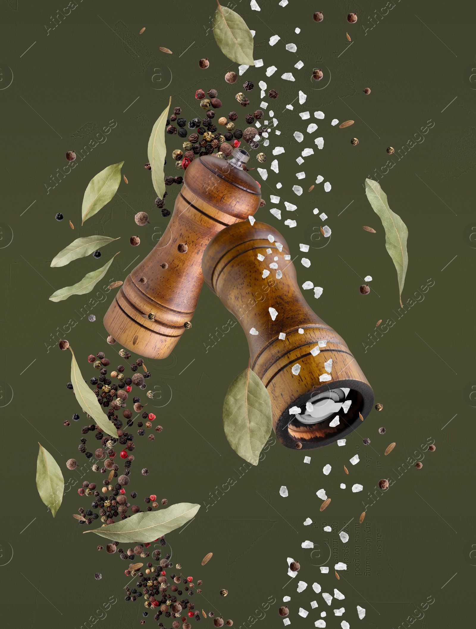 Image of Salt and pepper mills in air on olive color background