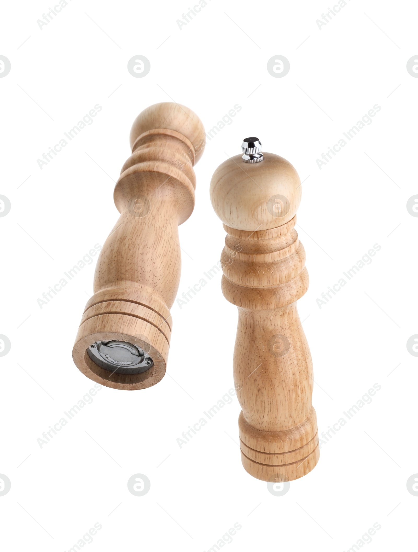 Image of Salt and pepper mills in air on white background