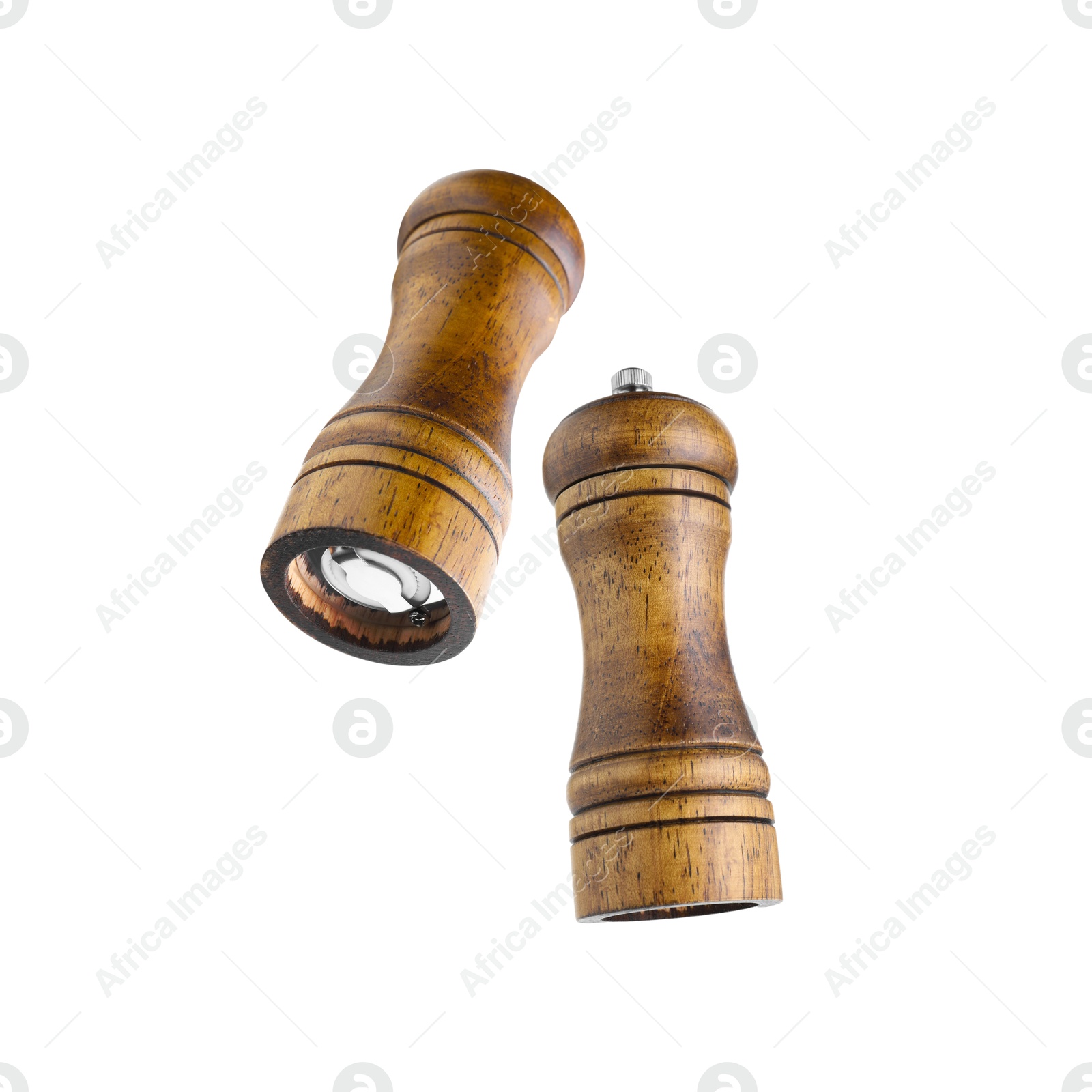 Image of Salt and pepper mills in air on white background