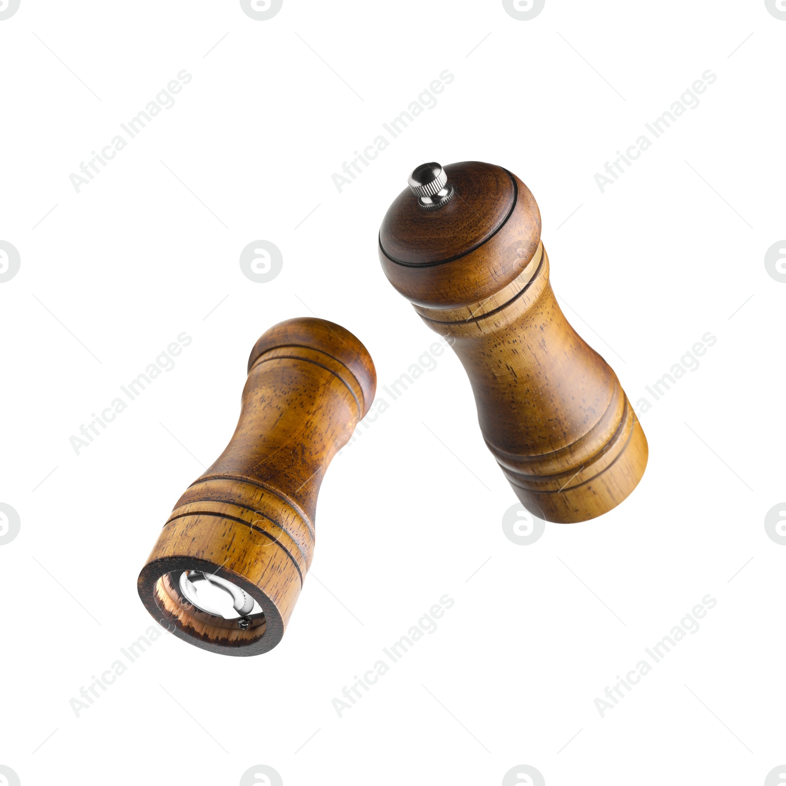 Image of Salt and pepper mills in air on white background