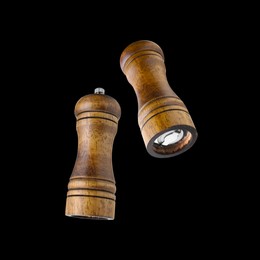 Image of Salt and pepper mills in air on black background