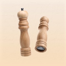 Image of Salt and pepper mills in air on dark beige background