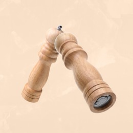 Image of Salt and pepper mills in air on dark beige background