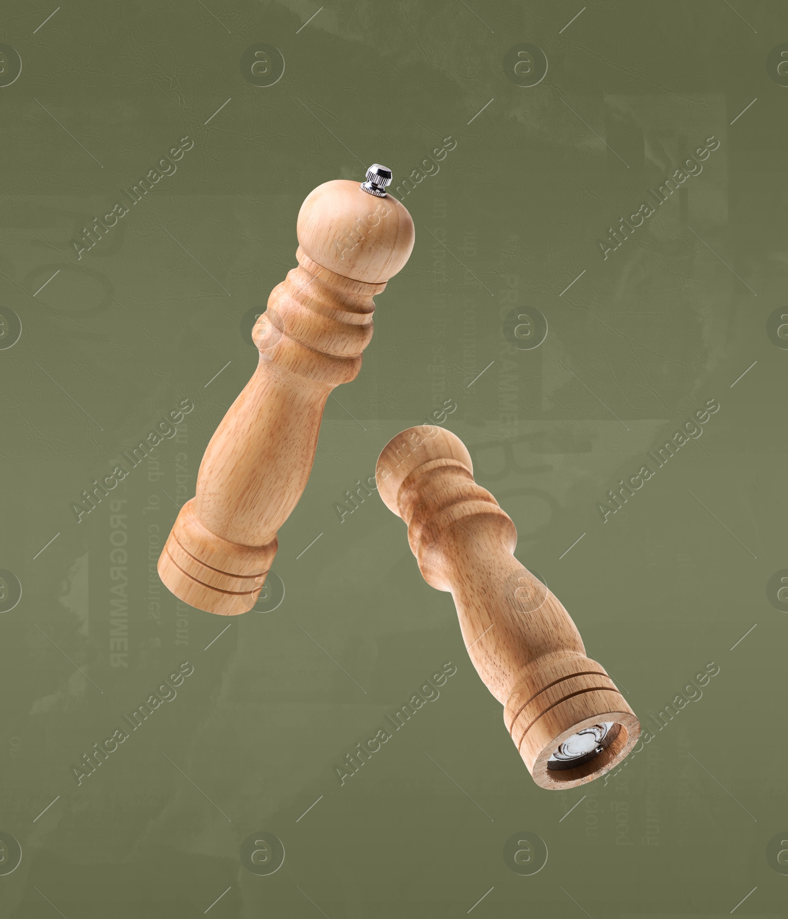 Image of Salt and pepper mills in air on olive color background