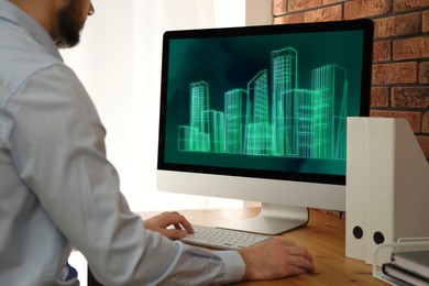 Image of Building information modeling. Man working at computer indoors, closeup. Digital project on display