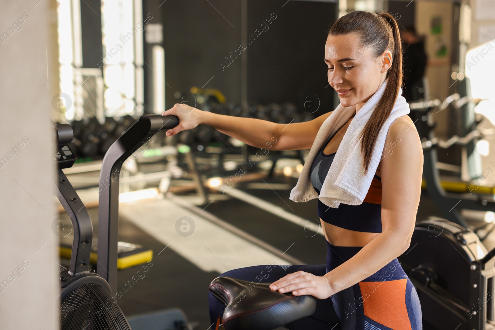 Photo of Happy woman with terry towel in gym