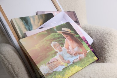 Photo of Canvas with different printed photos on armchair, closeup