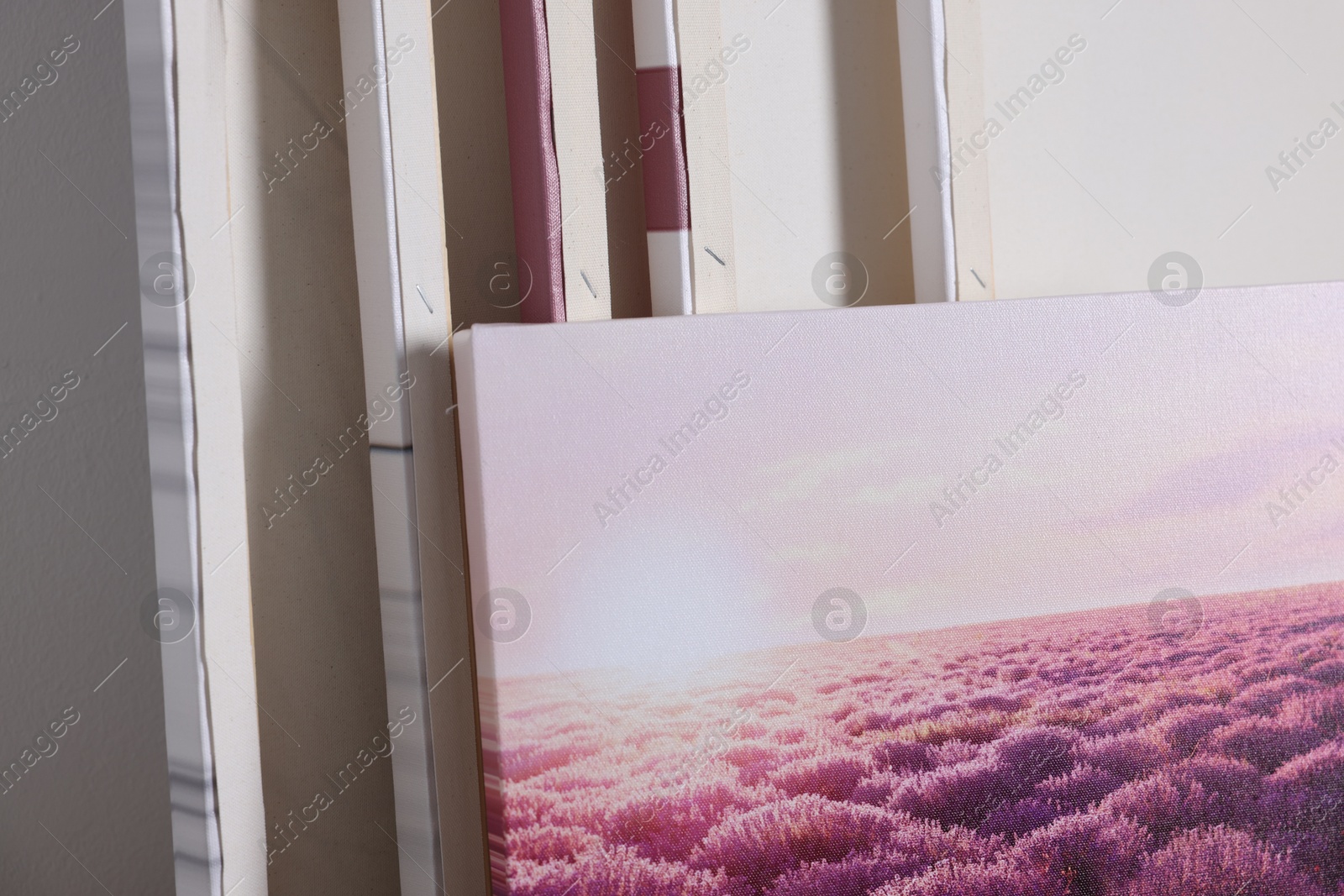 Photo of Canvas with different printed photos indoors, closeup