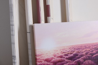 Photo of Canvas with different printed photos indoors, closeup