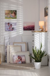 Photo of Canvas with different printed photos on wall indoors