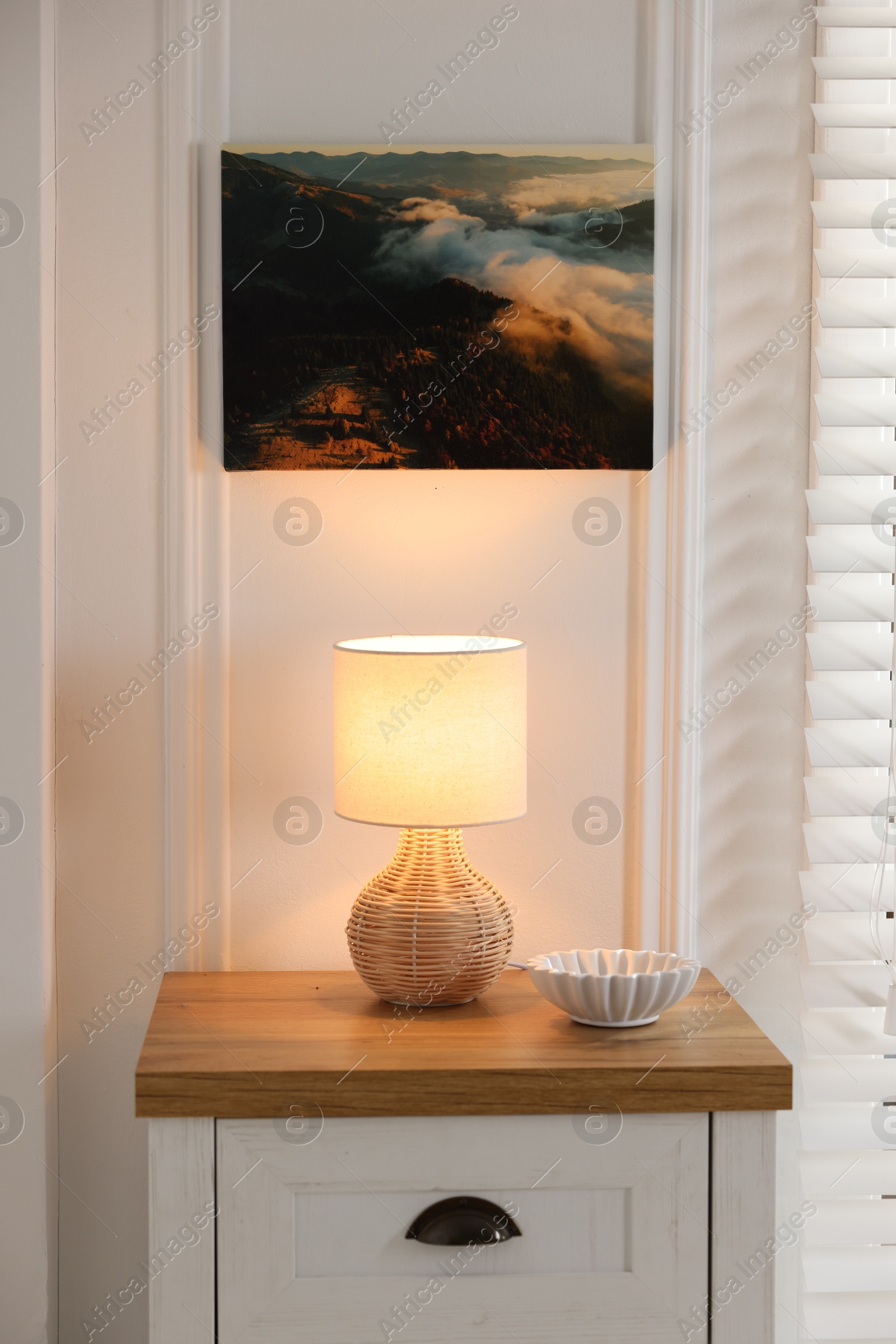 Photo of Canvas with printed photo of mountains on white wall indoors