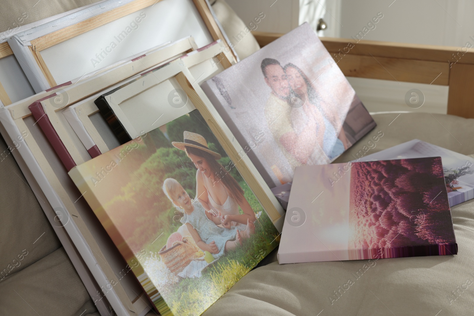 Photo of Canvas with different printed photos on sofa, closeup