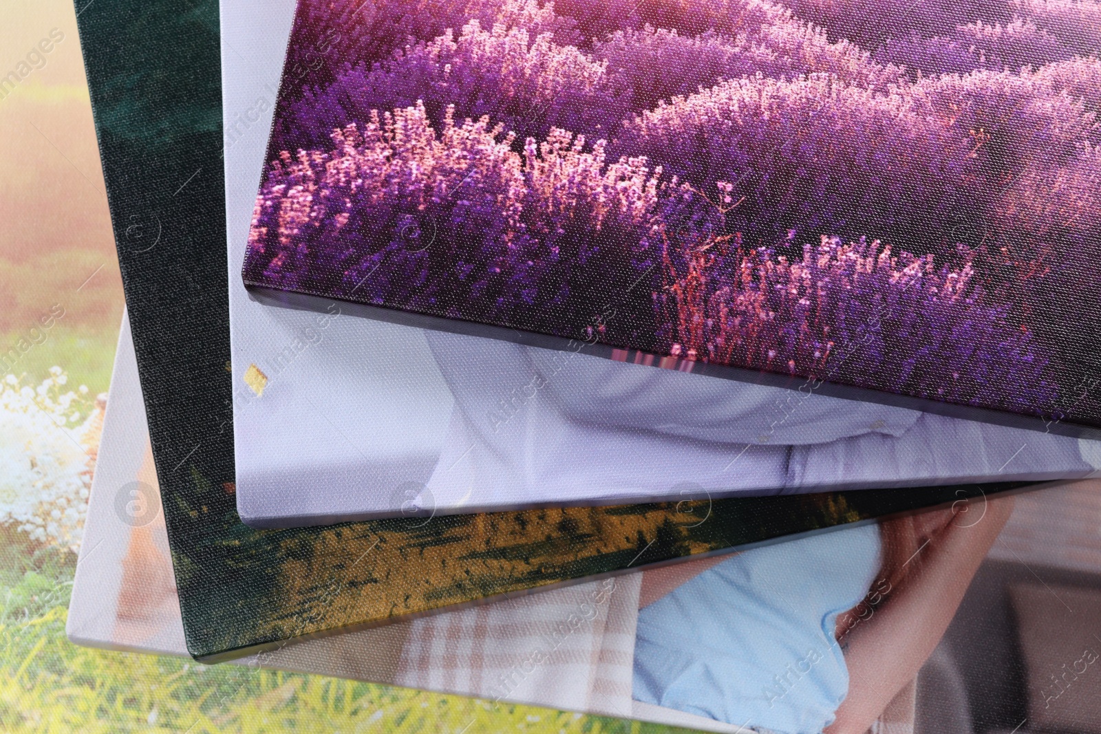 Photo of Canvas with different printed photos as background, closeup