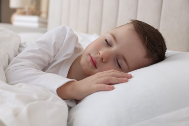 Photo of Bedtime. Cute boy sleeping in comfortable bed