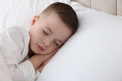 Photo of Bedtime. Cute boy sleeping in comfortable bed