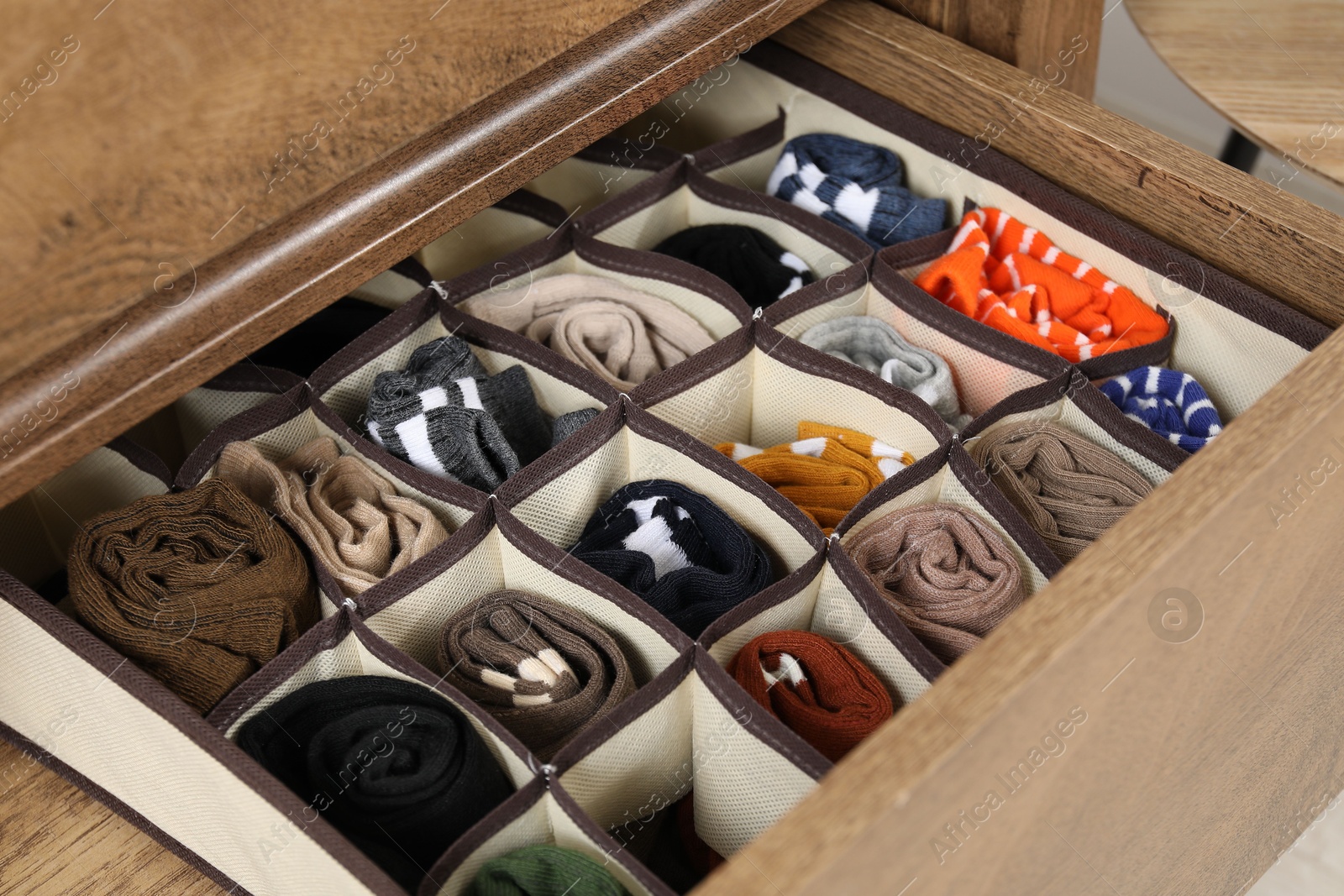 Photo of Organizer with different socks in drawer, closeup