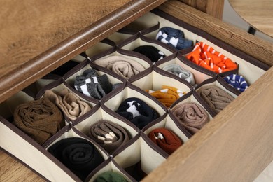 Organizer with different socks in drawer, closeup