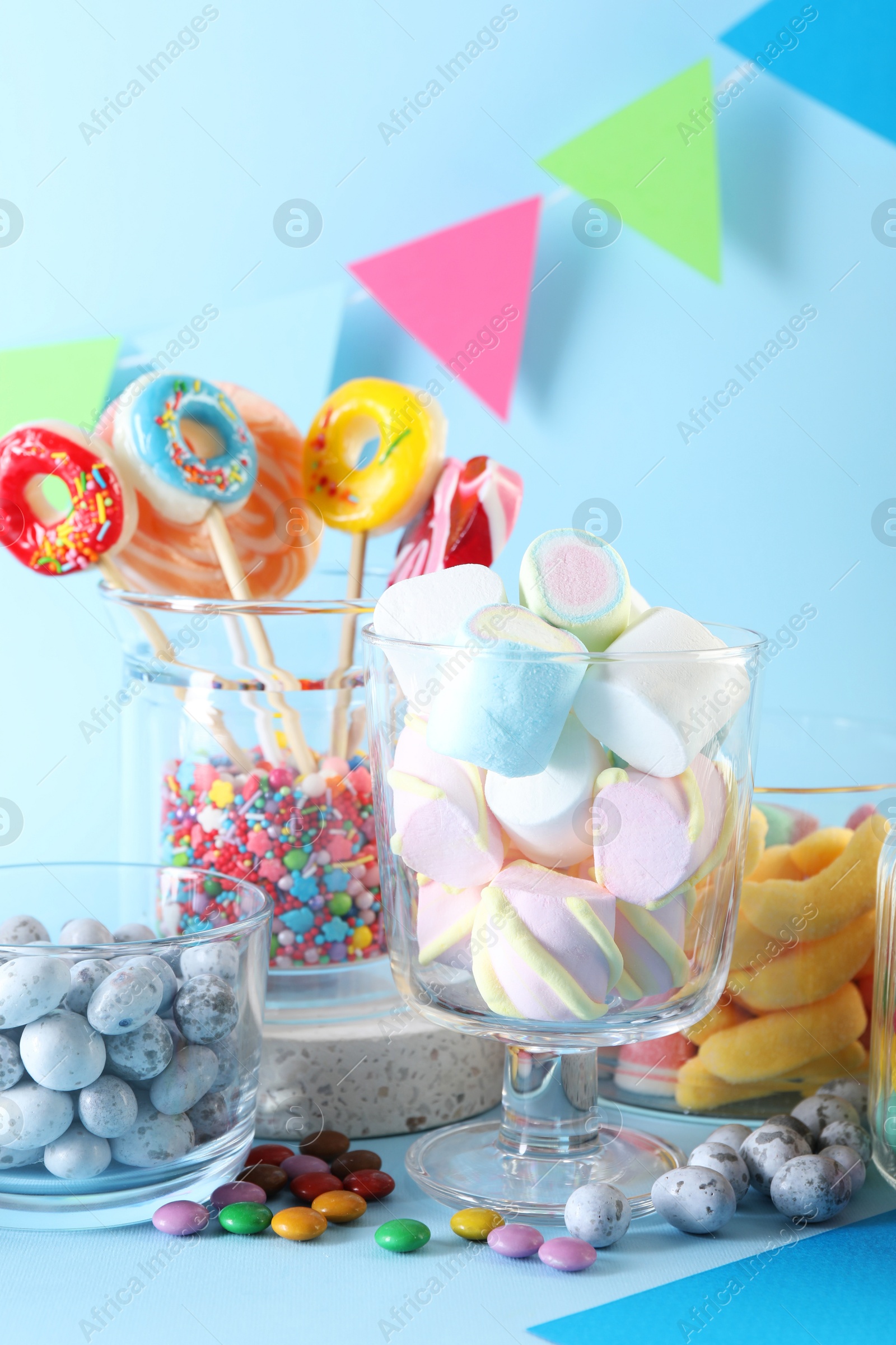 Photo of Candy bar. Many different sweets on light blue background