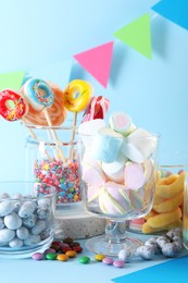 Candy bar. Many different sweets on light blue background