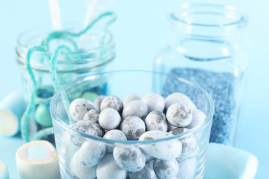 Candy bar. Many different sweets on light blue background, closeup