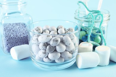 Candy bar. Many different sweets on light blue background, closeup