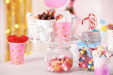 Candy bar. Many different sweets on table in festive decorated room