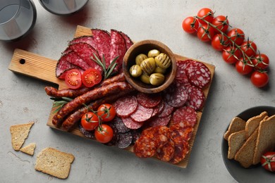 Different smoked sausages slices served on light table, flat lay