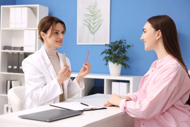 Gynecologist recommending contraceptive pills to woman in clinic