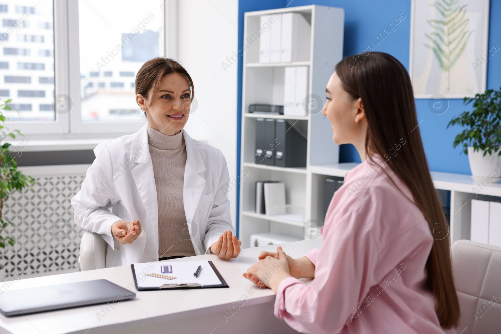 Photo of Contraception. Woman having appointment with gynecologist in clinic