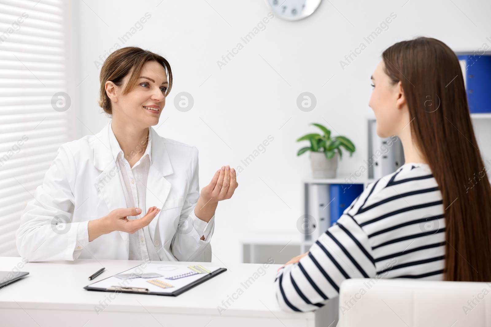 Photo of Contraception. Woman having appointment with gynecologist in clinic