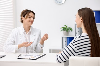 Photo of Contraception. Woman having appointment with gynecologist in clinic