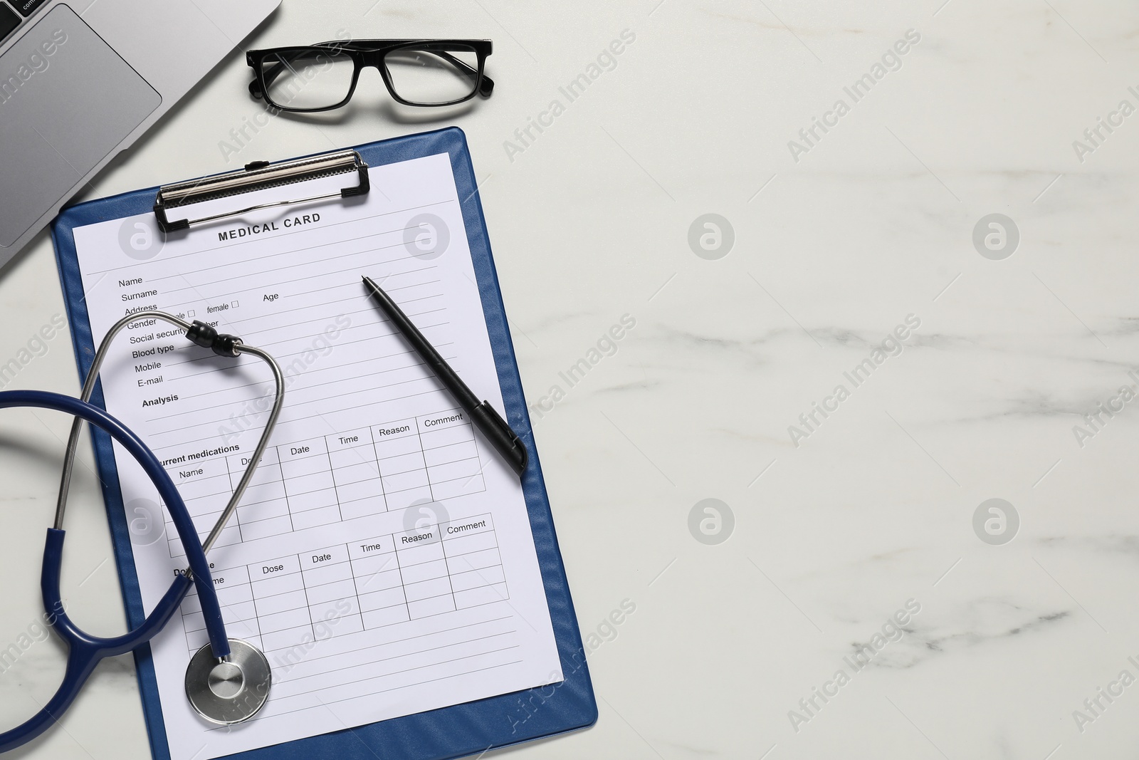 Medical card form, pen, glasses and stethoscope on white marble table, flat lay. Space for text Photo of Medical card form, pen, glasses and stethoscope on white marble table, flat lay. Space for text