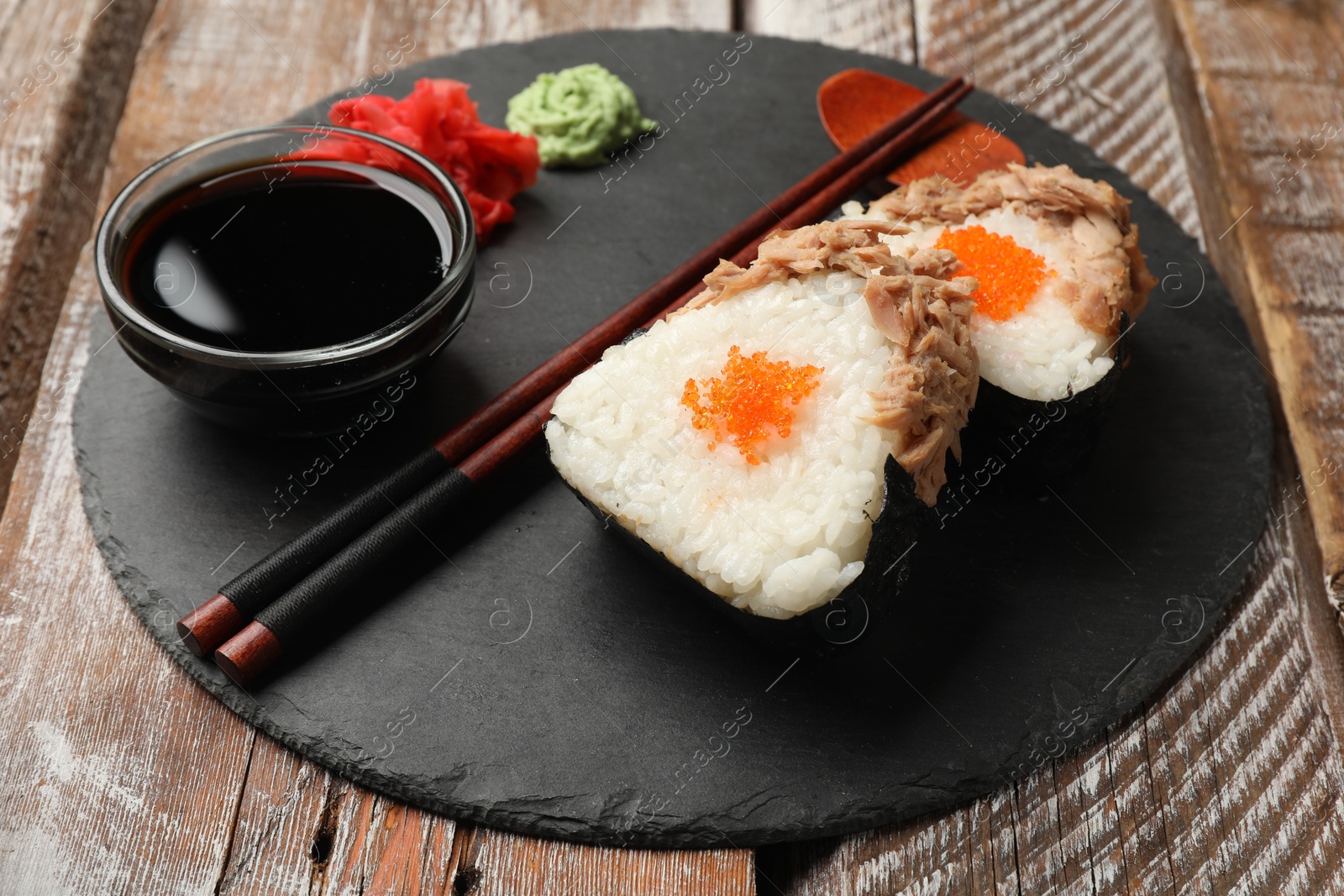 Tasty onigiri (Japanese rice balls) with tuna served on wooden table, closeup Photo of Tasty onigiri (Japanese rice balls) with tuna served on wooden table, closeup